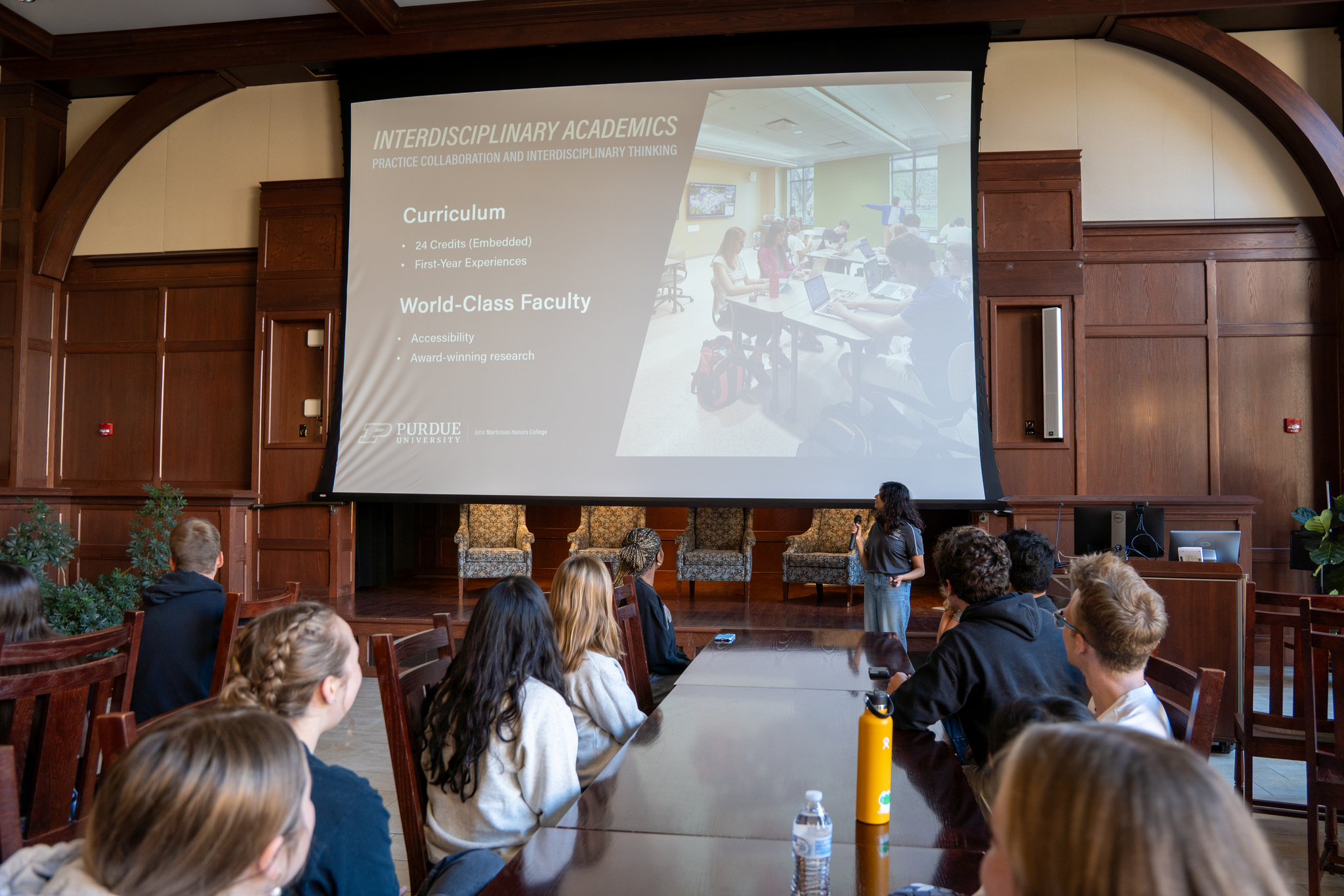 Students watching another peer give a presentation in Honors Hall.